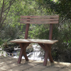 Photo of bench on a bridge over the creek